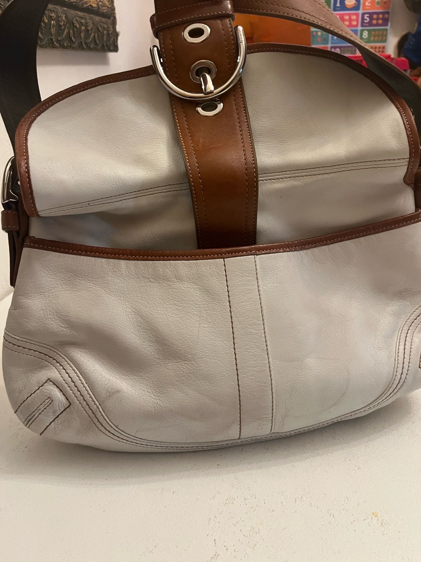 vintage white Coach Soho leather shoulder bag featuring a tan 