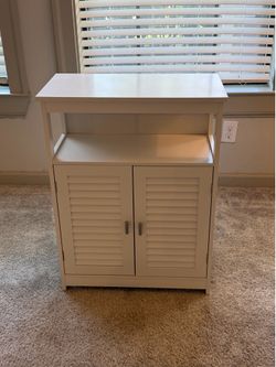 Bathroom storage cabinet with adjustable shelf - white color.