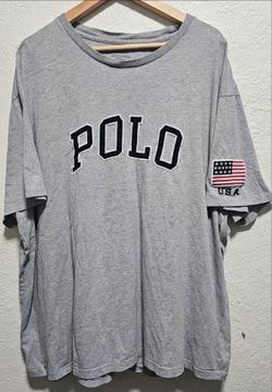 vintage Polo Ralph Lauren gray cotton t-shirt featuring a contrast block-letter spellout logo on the chest and an embroidered American flag patch on t