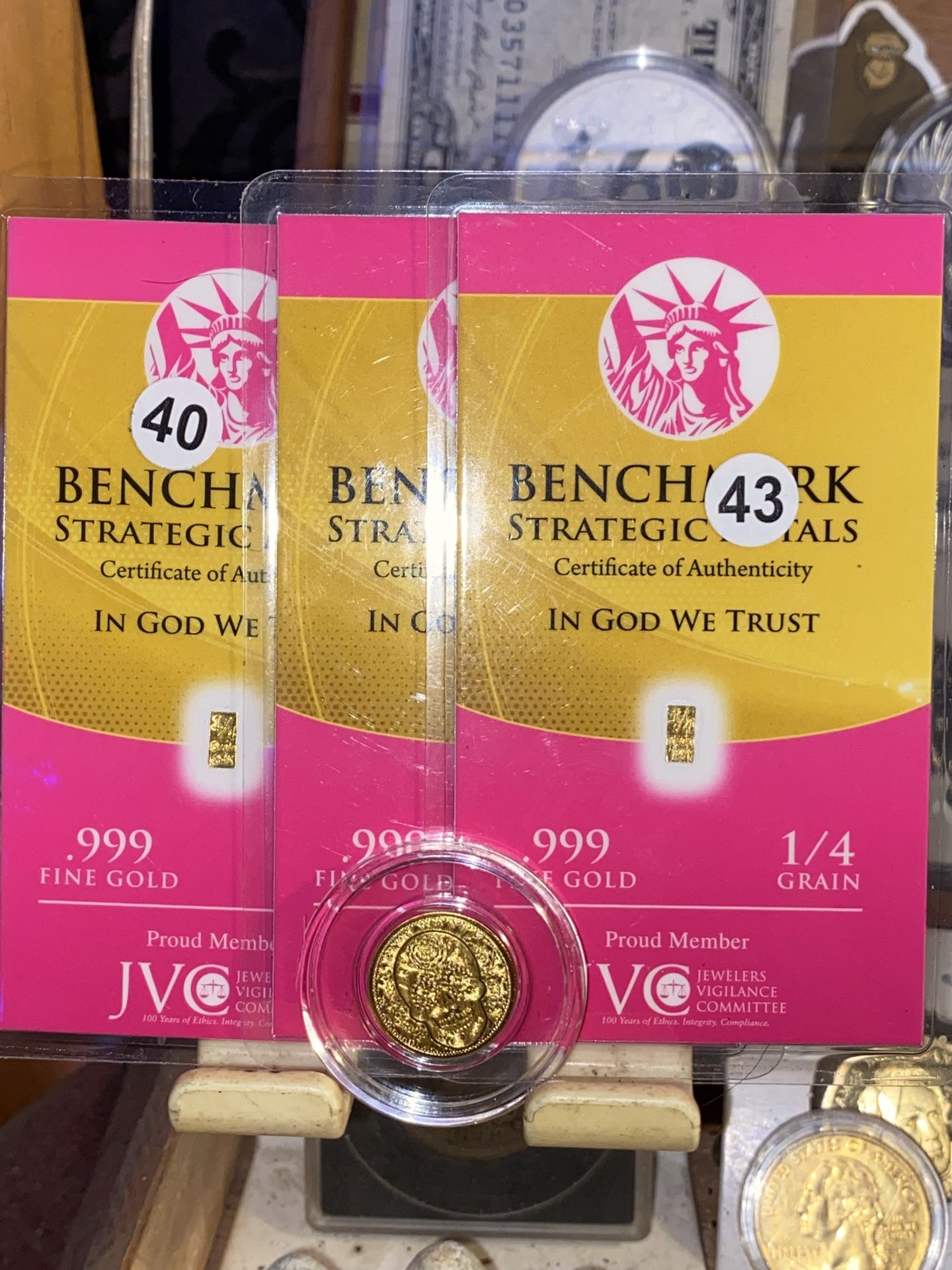 1/100th day of the dead gold coin and four individual 1/4 grain gold