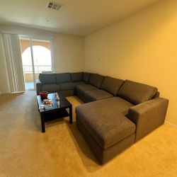 From LIVING SPACES: Sebastian Slate Grey Fabric 140" 3 Piece Convertible Futon Sleeper U-Shaped Sectional with Right Arm Facing Storage Chaise