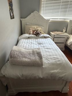 2 twin beds with mattress night stand and a dresser with mirror