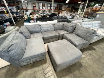 Grey modular sectional couch with ottoman
