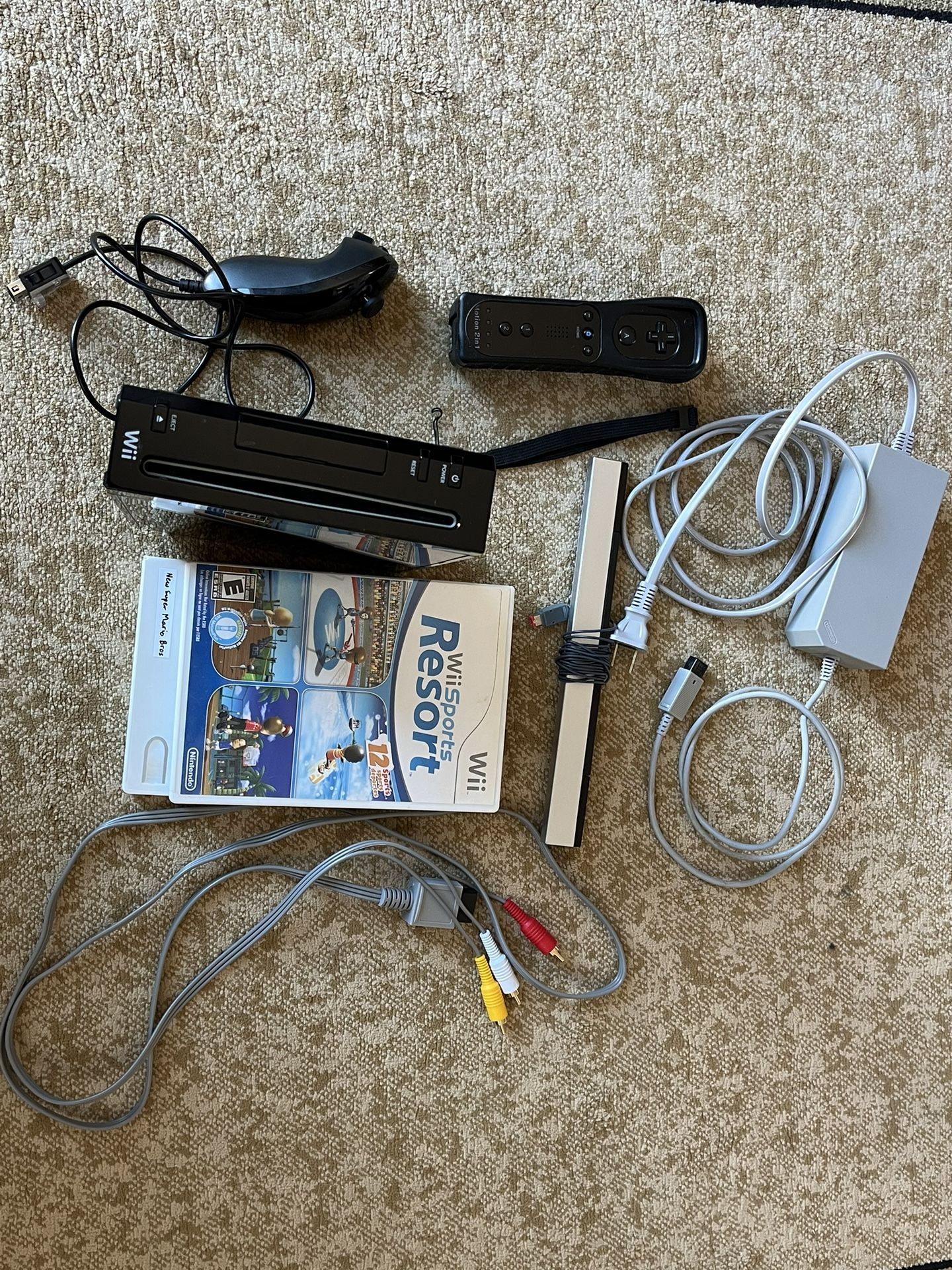 Nintendo Wii with Remote + Nunchuck And Wii Sports Resort + New Super Mario Bros Wii
