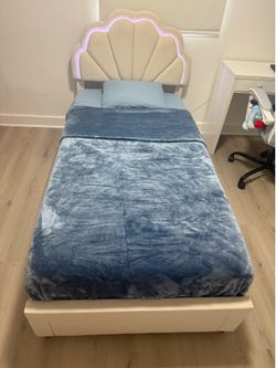 Beige Twin size bed with LED lights and storage drawer, mattress not included.