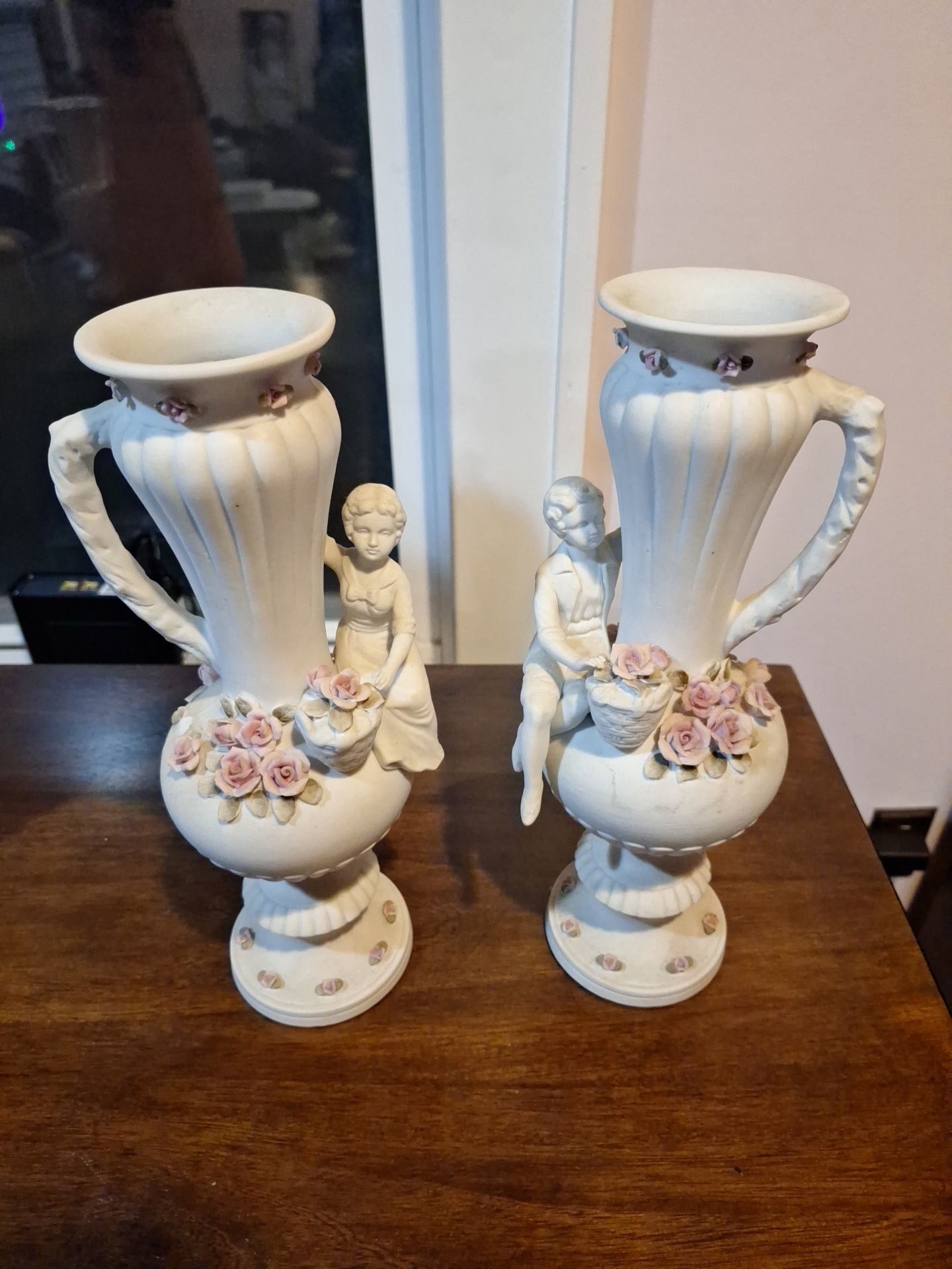 Pair of vintage decorative vases with boy and a girl figurine