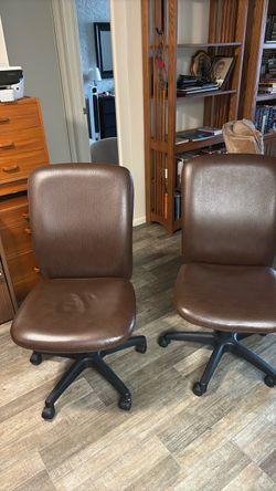 Two brown leather office chairs