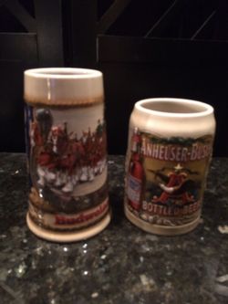 2 Budweiser beer steins, collector mugs.
