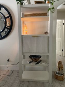 White Tall Shelf With Pull Down Door and Storage