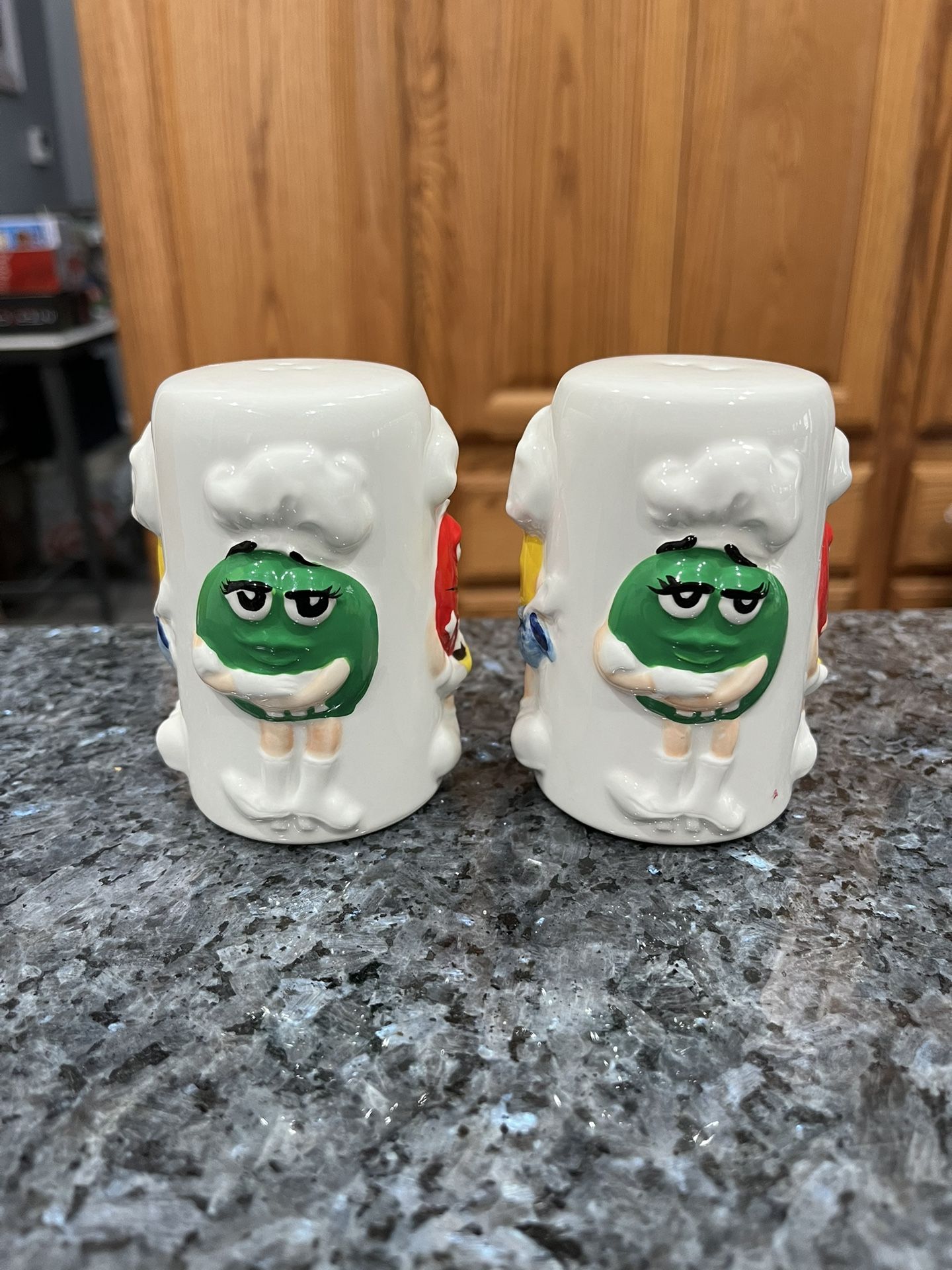 Ceramic White M&Ms with Red, Green and yellow Pair of Salt and Pepper Shakers. Size approximately 3 1/2 inches tall. Brand new never used.