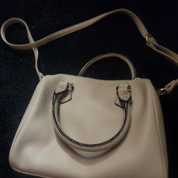 This is a Juicy Couture Be Classic Satchel handbag in dusty blush faux leather with a crystal logo. 