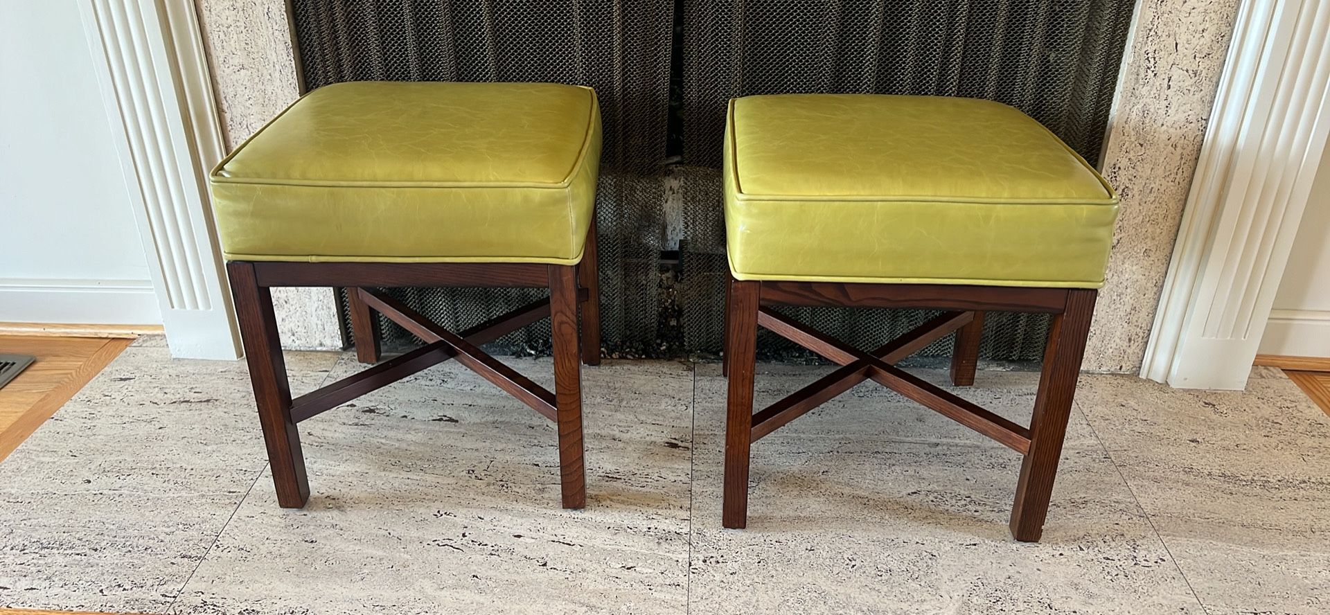 Two low stools with green leather cushion