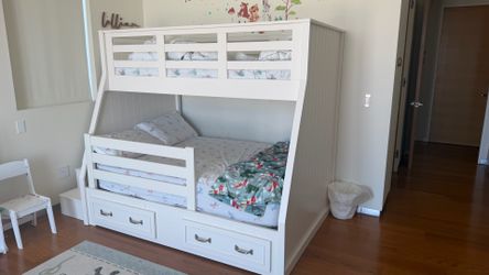 White twin-over-full bunk bed with storage drawers. Excellent condition.