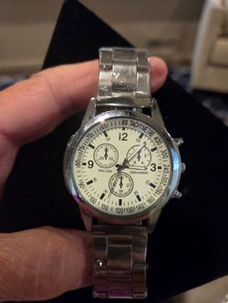 Mens watch plastic still on. Needs battery
