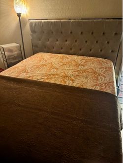 Grey tufted queen bed with mirror accent framing. Pickup Only