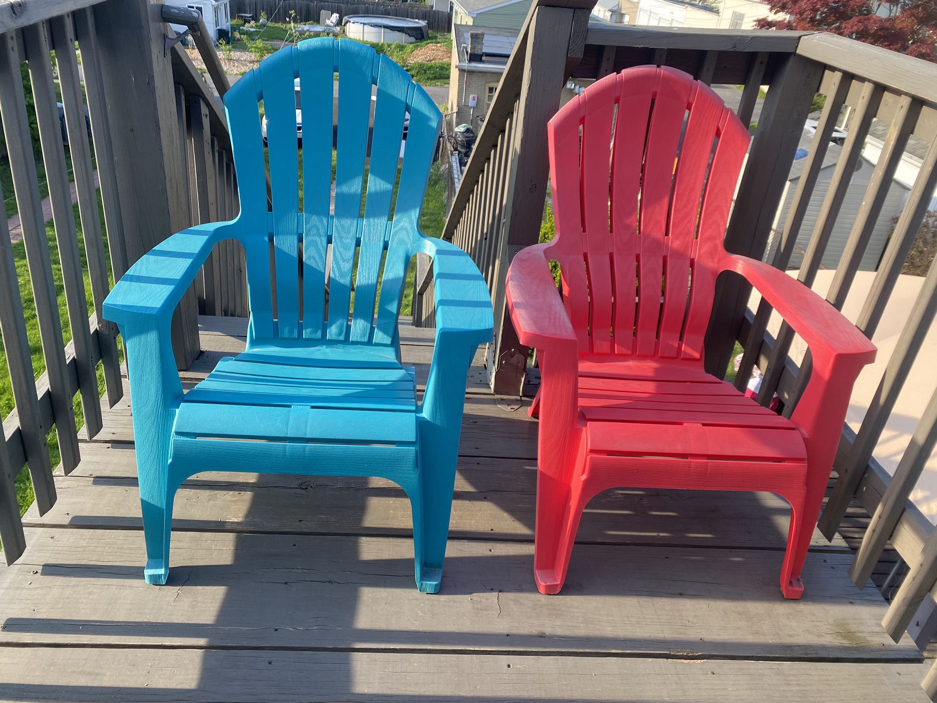 Two Plastic Adirondack Chairs