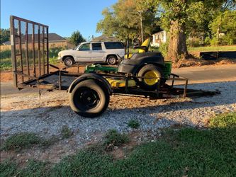 Riding lawn mower in a trailer