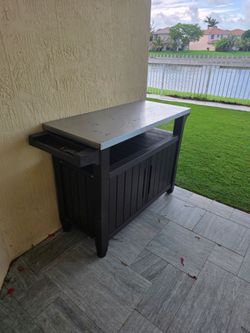 Stainless steal grill top with rolling wheels on one end