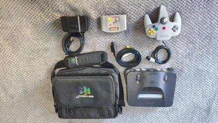 Super Nintendo 64 w/1 controller, Super Smash Bros game, and Nintendo 64 Bag.