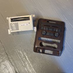 Ford Radio/ CD/ Receiver And Wood Grain Dash Piece. 