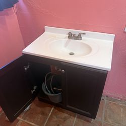 Bathroom cabinet and sink. Never screwed in or glued down!