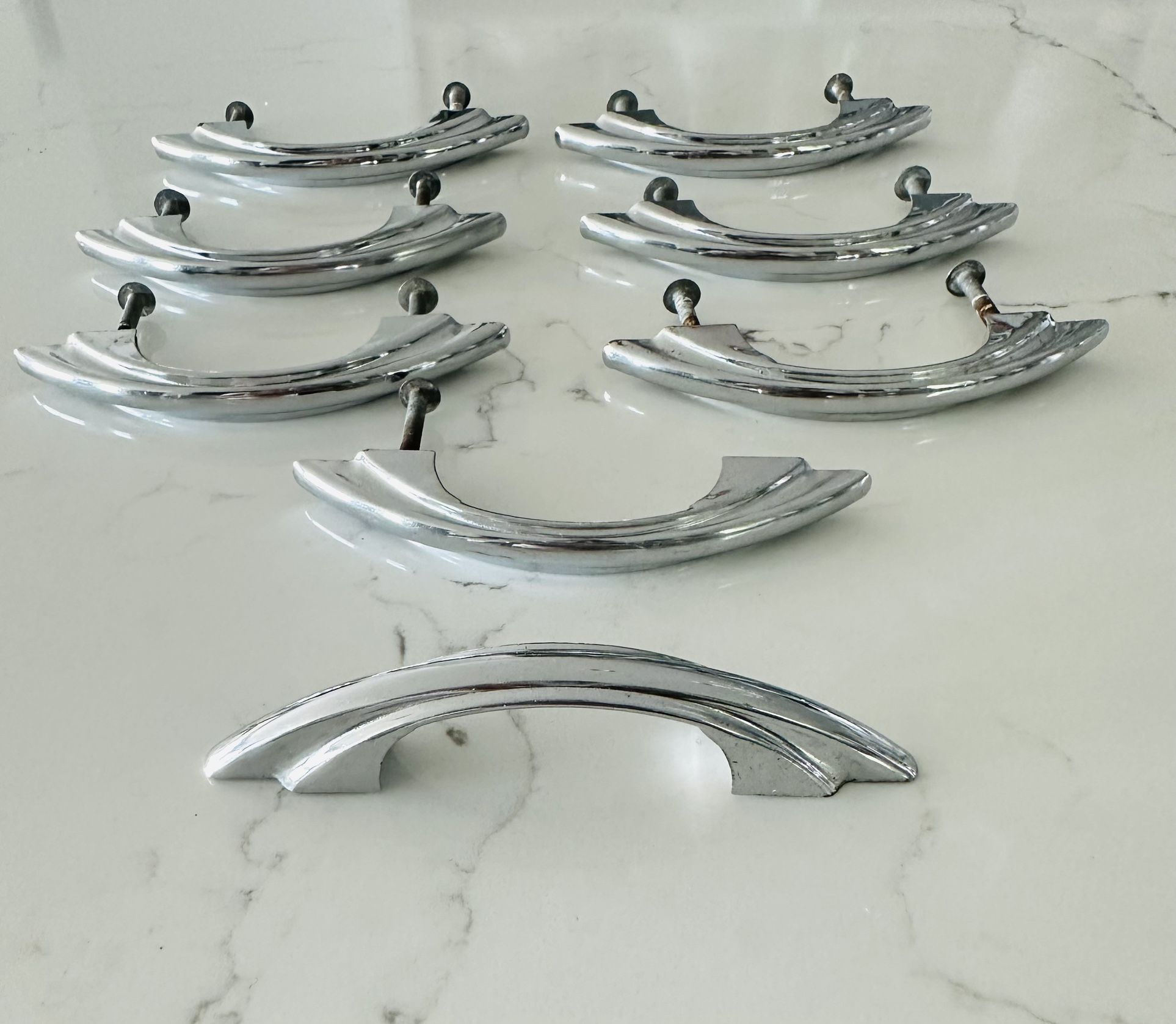 Set of 8 Vintage 50s cabinet door /drawer handle pulls chrome metal MCM Art Deco 4 1/2” long, overall. 2 3/4” inch from screw hole to screw hole.