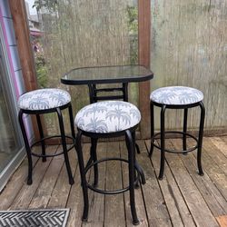 Glass top bar height table and 3 Swivel Stools