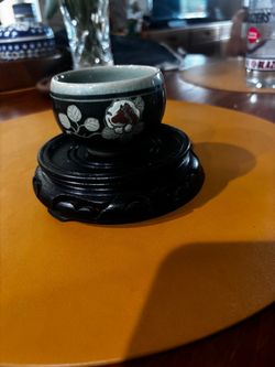 Korean celadon tea cup with wooden plant stand