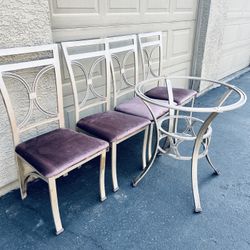 a table without glass and four chairs