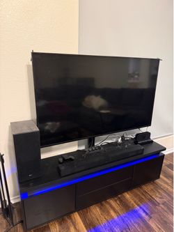 55in Samsung 4K TV, LG SPEAKER BUNDLE, and entertainment console