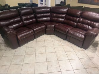 Brown leather sectional couch with electric seating and entertainment center