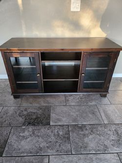 Dark wood TV Armoire or Dresser with 2 glass doors.  $100