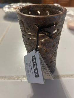 carved brown soapstone candle or tealight holder, similar to decorative aromatherapy pieces like the Yankee Candle Soapstone Rose Dark Candle Holder