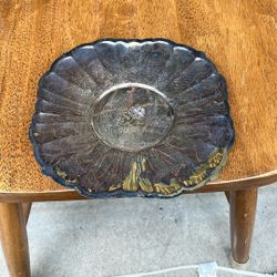 The item pictured appears to be a tarnished vintage platter or bowl, likely silver-plated, with a decorative scalloped edge and a sunburst or floral p