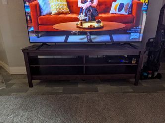 TV Stand 65 in on it in the picture