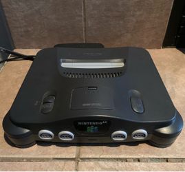 Nintendo 64 with games, controllers, and game case