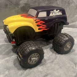 Vintage The Animal Battery Operated Toy Truck Yellow/Purple Claw Wheels