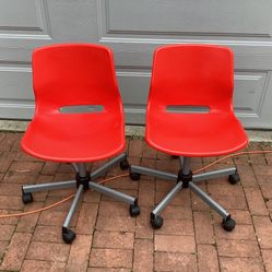 Red armless plastic rolling chair - 2 items ( pair of chairs ), used, adjustable height , set. Price is for both chairs. 