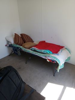 Cott With Pillows And Blankets