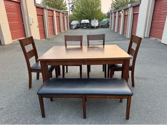 Wooden table and four chairs and a bench