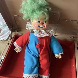 vintage collectible clown doll with a molded face, green yarn hair, and a red and blue costume.  Item Type: Collectible clown figurine. Features: Typi
