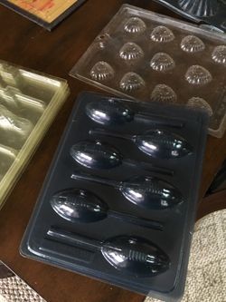 Assorted plastic chocolate molds everything from Easter to Christmas and sports some used some new some mold have more the one some are single molds