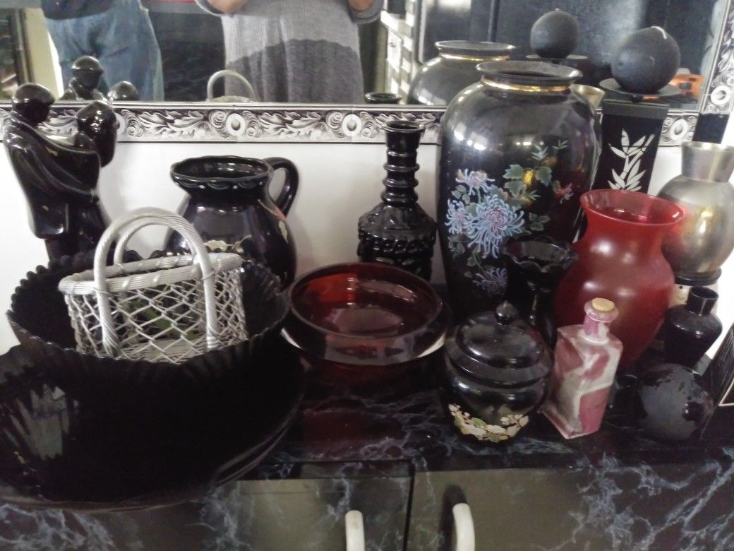 A Gathering Of Black &red Knick Knacks And fake flowers