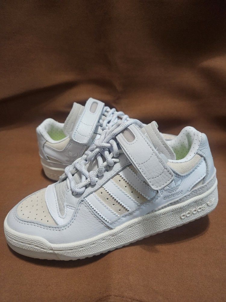 pair of Adidas Ivy Park x Forum Low sneakers in a white colorway