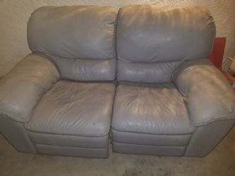 Grey leather couch that both sides recline