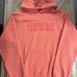 Fear of God Essentials hoodie in a coral colorway