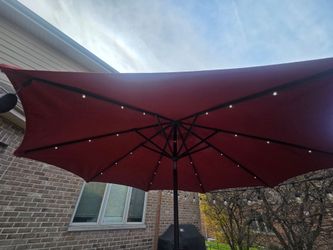 2 used red outdoor umbrellas