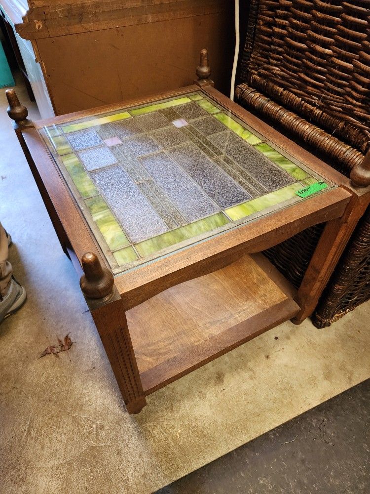 Antique two tier table with leaded glass window top. Has a solid glass topper