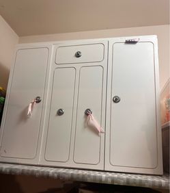 Wooden dolls closet with some accessories.