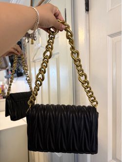 Black shoulder bag with thick gold chain